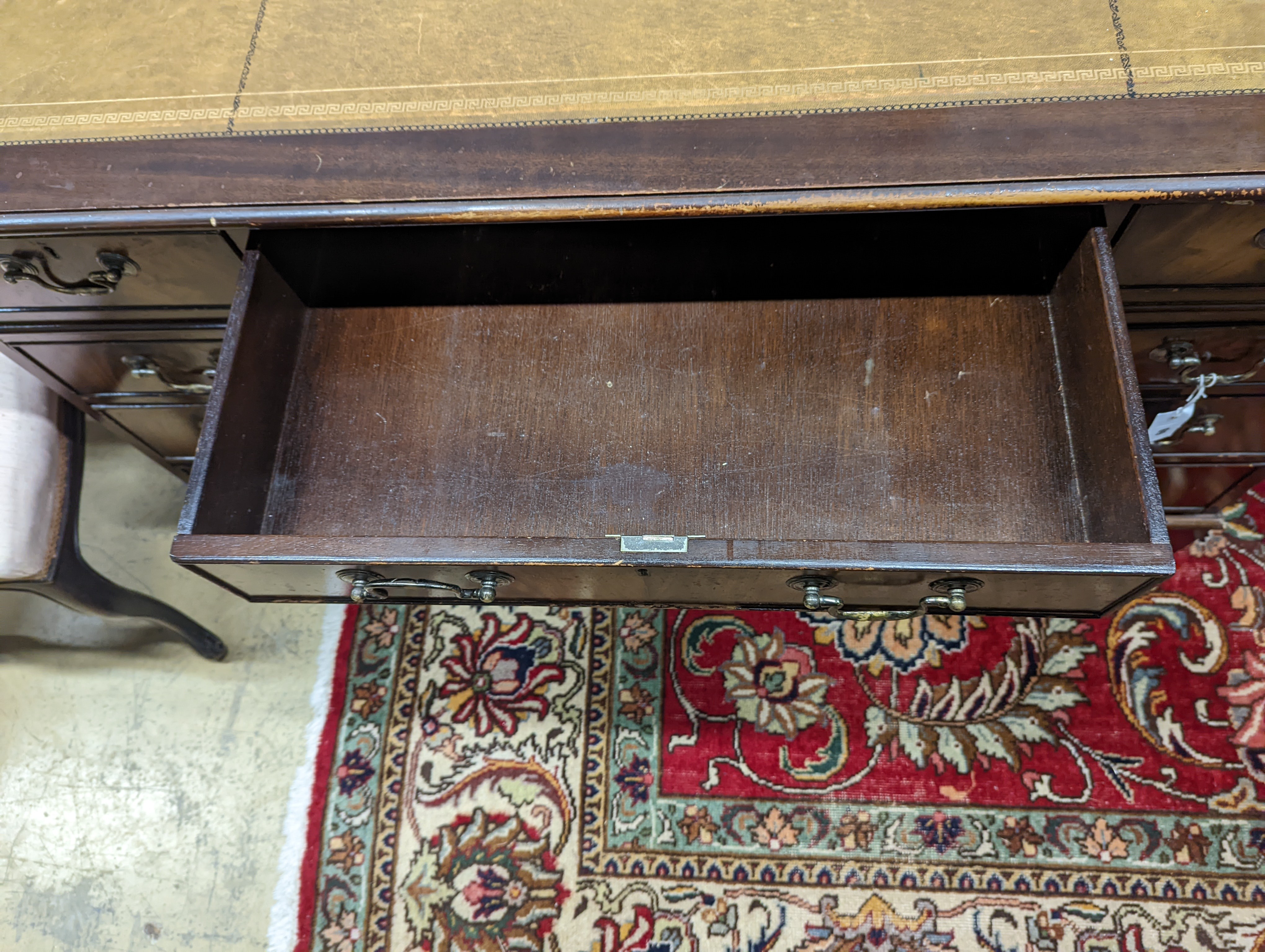 A reproduction mahogany pedestal desk, length 138cm, depth 69cm, height 79cm